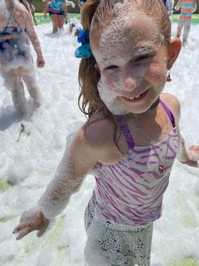 cute girl enjoying a foam party